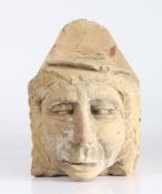 An unusual sandstone corbel, possibly 18th century Probably designed as an academic, wearing a