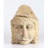 An unusual sandstone corbel, possibly 18th century Probably designed as an academic, wearing a