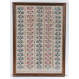 A 19th century sampler Designed with five rows of blue and red flowers, 33cm wide, 48cm high
