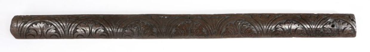 An Elizabeth I oak bed headboard rail, circa 1580 Of cushion-form, carved with a run of leafy-filled