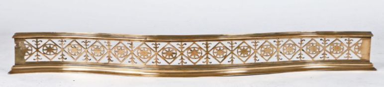 A George III brass pierced fender, circa 1800 Of serpentine form, designed with a band of star-