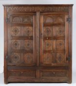 A Charles II oak livery cupboard, circa 1660 Having leafy-lunette interlaced carved top rails,