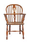 A mid-19th century ash and elm Windsor armchair, circa 1840 The hooped back with a pierced splat