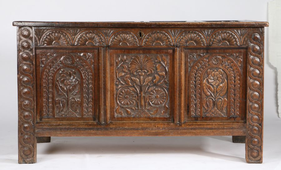 A Charles I oak coffer, West Country, circa 1640 Having a quadruple-panelled lid, the front with two