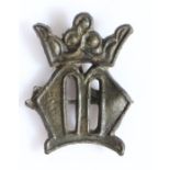 A 14th/15th century pewter pilgrims badge Designed with a crowned letter 'M', to represent Mary,