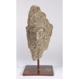 A carved stone head, possibly 14th century Of triangular form, designed as a bearded man with a