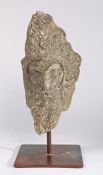 A carved stone head, possibly 14th century Of triangular form, designed as a bearded man with a