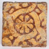 A 14th century floor tile, English  Decorated in yellow slip with an octofoil flower within an