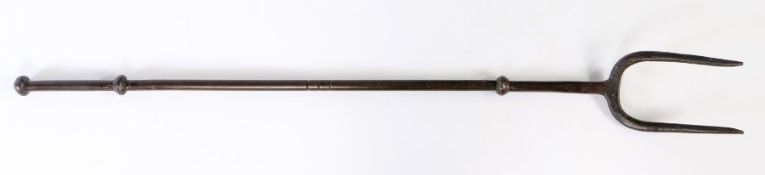 A 19th century wrought iron log or fire fork With knopped decoration to stem and two arched tines,