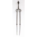 An interesting pair of late 17th century steel and bronze alloy fire tongs, English Topped by a