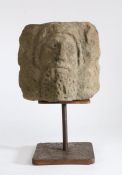 A carved gritstone head, possibly 12th century Designed as a male, with full-beard, rounded
