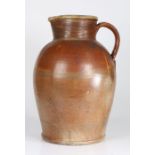 An exceptionally large late 17th century stoneware jug Having a baluster-shaped body, with high
