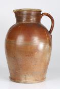 An exceptionally large late 17th century stoneware jug Having a baluster-shaped body, with high
