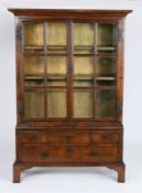 A small George I walnut and oak bookcase cabinet, circa 1720 and later In two parts, with cyma-recta