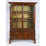 A small George I walnut and oak bookcase cabinet, circa 1720 and later In two parts, with cyma-recta