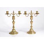 A pair of  mid-18th century brass candelabra, French, circa 1760 In the Rococo manner, each with a