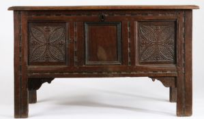 A Charles II oak coffer, circa 1670 Having a triple-panelled lid, the front again with three panels,