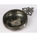 A good pewter porringer, English, circa 1680-1720 The bellied bowl with bossed base, having a