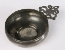 A good pewter porringer, English, circa 1680-1720 The bellied bowl with bossed base, having a