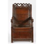 A Charles II oak panel-back and box-seated open armchair, Cheshire, circa 1670 Having a plain