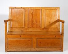 An early 19th century pine and oak box-settle, Welsh, circa 1820-50 The rectangular back of three