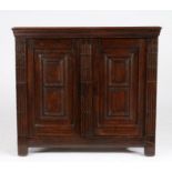 A small late 17th century oak and walnut side cabinet, circa 1680 Having a one-piece walnut top with