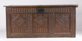 A Charles I oak coffer, West Country, circa 1640 The boarded lid with chip-carved, dog-tooth and
