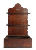 A George III oak spoon rack, circa 1800 The arched back plate with two spoon aperture rails, the