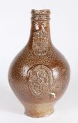 A 17th Century Bellarmine stoneware jug, the reeded lip above a bearded mask and medallion to the