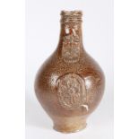 A 17th Century Bellarmine stoneware jug, the reeded lip above a bearded mask and medallion to the