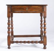 A Charles II oak side table, circa 1680 Having a boarded top with square-edge, a frieze drawer