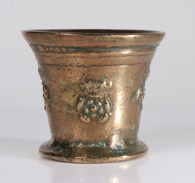 A small 17th century bronze mortar, English, circa 1650-80 Cast with a pair of cords, and four times