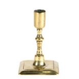 A good dwarf brass candlestick, circa 1700 In the Huguenot manner, having a plain straight-sided