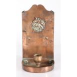 An Arts & Crafts sheet copper chamberstick, circa 1900 Having a gently curved backplate, centred