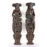 A pair of early 17th century oak figural terms, circa 1600-20 Each carved in high relief, designed