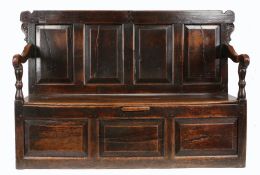 A William & Mary oak box-settle, Yorkshire, circa 1700 Having a rectangular back of four fielded