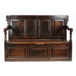 A William & Mary oak box-settle, Yorkshire, circa 1700 Having a rectangular back of four fielded