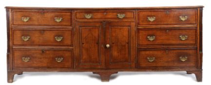 A George III oak and inlaid fully-enclosed dresser base, Cheshire, circa 1770 Having a two-plank and