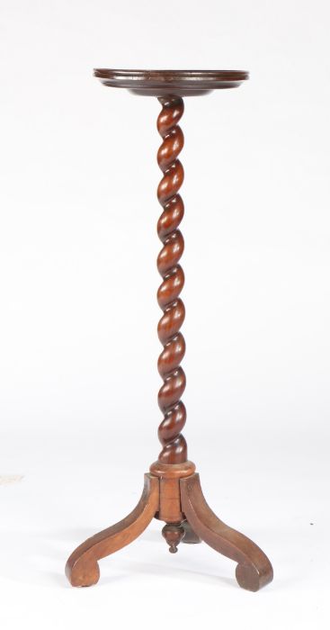 A late 17th century walnut candlestand, circa 1690 and later Having a circular dished top, on a