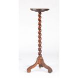 A late 17th century walnut candlestand, circa 1690 and later Having a circular dished top, on a