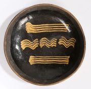 A George III slip-decorated earthenware dish, Staffordshire, circa 1780 Of circular form,