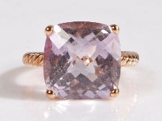 A 14 carat rose gold and amethyst coloured stone ring, the head set with a claw mounted square cut