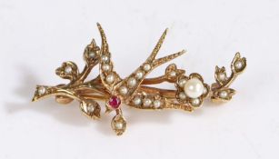 A 9 carat gold and gem-set antique swallow brooch, depicting a single swallow across a branch with