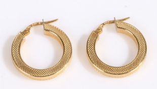 A pair of 18 carat gold hoop earrings, the earrings with a hatched decoration, weight 3.0 grams