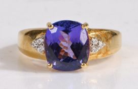 A 18 carat gold AAA tanzanite and diamond ring, the head set with a claw mounted antique cut AAA