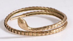 A gold snake arm bangle, the flexible coiled bracelet is formed of concentric scale like steel