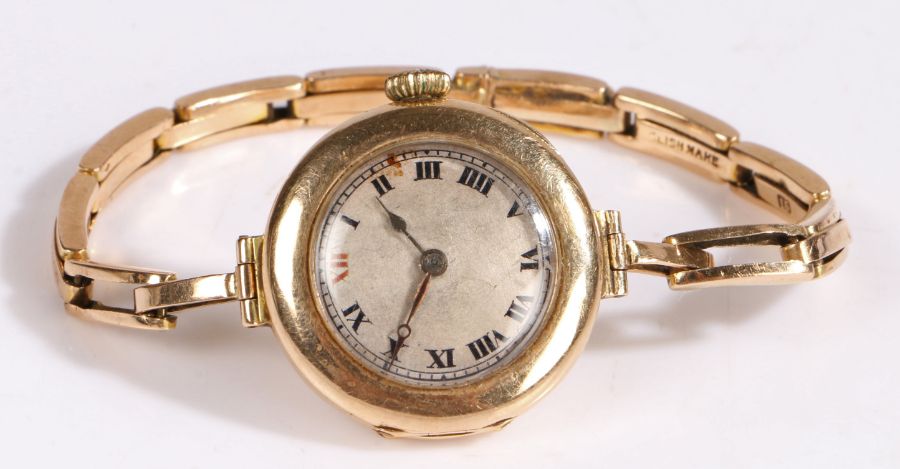 An early 20th century 15 carat gold manual wind Rolex ladies wristwatch, with a silvered dial with