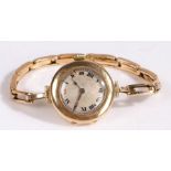 An early 20th century 15 carat gold manual wind Rolex ladies wristwatch, with a silvered dial with