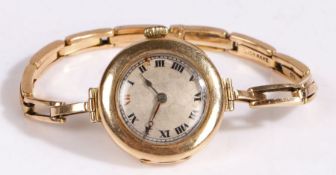 An early 20th century 15 carat gold manual wind Rolex ladies wristwatch, with a silvered dial with