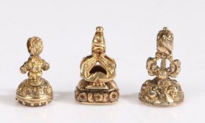 A set of three antique fob seals, each intricately engraved with scroll and foliate design and gem-